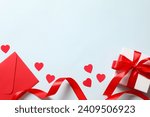 Beautiful present and red paper envelope and Valentines hearts on blue background. Flat lay, top view. Romantic love letter for Valentine's day concept.