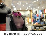 Man and woman mannequin in sport bra and trouser. The mannequin using earphone. Background with blurry sport product in retail store. Concept shopping mall, Sell and buy sport suit, active exercise. 