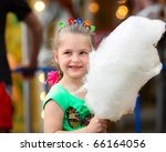 Four years old  girl with white cotton candy.