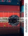 Small photo of Seattle, WA, USA May 23, 2023 Audi R8 parked behind a puddle with shipping containers in the background