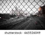 City skyline through the wire mesh fence. Abstract blurred cityscape background