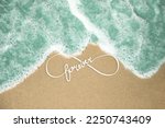 loop symbol inspirational view, sea beach with blue salty water running on beach sand, top view of sea coast in sun light, forever typography on ocean beach.