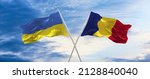 two crossed flags romania and Ukraine waving in wind at cloudy sky. Concept of relationship, dialog, travelling between two countries. 3d illustration