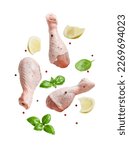 Raw flying chicken drumstick And spices cut out on a white background