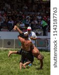 Small photo of EDIRNE, TURKEY - JULY 14, 2018 : Middle weight wrestlers battle for victory at the Kirkpinar Turkish Oil Wrestling Festival in Turkey.