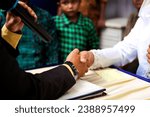 Small photo of Bandung, Indonesia - October 29th 2023: Sharia muslim wedding ceremony. The groom's hand shook hands with the bride's guardian. It's called Ijab Kabul