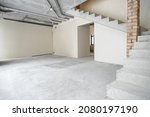 Small photo of The room is under construction with a rough finish, plastered walls, concrete floor. Wiring of ventilation pipes on a concrete ceiling in a house under construction.