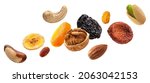 Small photo of Nuts and dried fruits isolated on white background