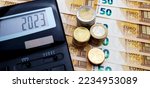 Small photo of Energy and financial crisis in Europe in 2023. The ever-increasing cost of energy, food and goods. Calculator and a lot of euro coins on the background of banknotes of 50 euros