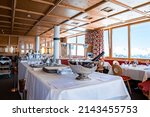 Small photo of St. Anton am Arlberg. March 10, 2022. Champagne bottle in ice bucket with luxury elegant table setting in restaurant, Champagne bottle in bucket with ice on table in hotel