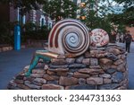 Small photo of London, UK. July 10,2023. The half human sculpture depict human body parts extending from the shells of snail and molluscs. Earthling artworks by Jocelyn McGregor’s In London at Aldgate square