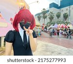 Small photo of cute Japan anime cosplay, portrait of a girl with the red beryl comic costume, a cosplay girl with red wig and black mask.