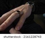 Small photo of Golden Signet Ring ang Black Leather Watch