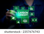 Small photo of Green energy, Carbon credit market concept. Businessman pointing Carbon credit icon. Net zero in 2050 year. Green energy icon around it. Carbon Neutral in industry Net zero emission eco energy.
