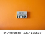 Do better symbol. Wooden blocks with words Do better. Beautiful orange background. Business and Do better concept. Copy space.