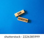 Small photo of Gather momentum symbol. Wooden blocks with words Gather momentum. Beautiful blue background. Business and Gather momentum concept. Copy space.