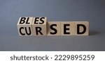 Small photo of Blessed vs Cursed word symbol. Turned wooden cubes with words Cursed and Blessed. Beautiful grey background. Religious and Blessed vs Cursed concept