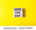 Small photo of Seize the day symbol. Wooden blocks with words Seize the day. Beautiful yellow background. Business and Seize the day concept. Copy space.