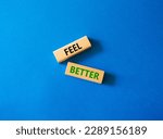 Feel better symbol. Wooden blocks with words Feel better. Beautiful blue background. Business and Feel better concept. Copy space.