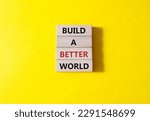 Build a better world symbol. Concept words Build a better world on wooden blocks. Beautiful yellow background. Business and Build a better world concept. Copy space.