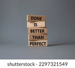 Done is better than Perfect symbol. Wooden blocks with words Done is better than Perfect. Beautiful grey background. Business and Done is better than Perfect concept. Copy space.