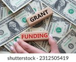Small photo of Grant funding symbol. Wooden blocks with words Grant funding. Beautiful dollar background. Businessman hand. Business and Grant funding concept. Copy space.
