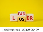 Small photo of Leader vs Loser symbol. Wooden cubes with words Loser and Leader. Beautiful yellow background. Leader vs Loser and business concept. Copy space