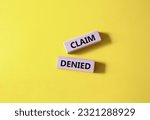 Small photo of Claim denied symbol. Wooden blocks with words Claim denied. Beautiful yellow background. Business and Claim denied concept. Copy space.