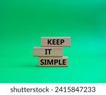 Small photo of Keep it Simple symbol. Concept words Keep it Simple on wooden blocks. Beautiful green background. Business and Keep it Simple concept. Copy space.