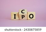 Small photo of ICO and IPO symbol. Wooden cubes with words ICO - initial coin offering and IPO - initial public offering. Beautiful pink background. Business concept. Copy space
