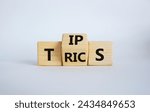 Small photo of Tips and Tricks symbol. Wooden cubes with words Tricks and Tips. Beautiful white background. Business and Tips and Tricks concept. Copy space