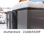 Small photo of Two residential modern heat pumps buried in snow