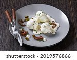 Small photo of Oeuf mayonnaise, hard boiled eggs covered with a sauce consisting of mayonnaise garnished with snipped chives, capers, and anchovy fillet on a plate, french cuisine