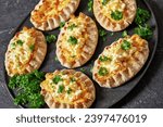 Small photo of Karelian pasties, karelian pies, pirogs, karjalanpiirakka, classic Finnish pastries of thin rye crust with rice filling, topped with butter mixed with chopped-up boiled eggs, close-up