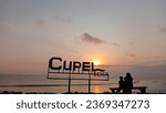 Small photo of Jembrana 30 September 2023, the afternoon atmosphere on the edge of Cupel beach which shows a mother and child enjoying the very beautiful evening view