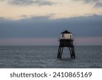 Small photo of Lighthouse in the sea at sunset, Dovercourt low lighthouse at high tide built in 1863 and discontinued in 1917 and restored in 1980 the 8 meter lighthouse is still a iconic sight