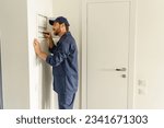 Professional male electrician inspect and repairing electrical systems in houses using a screwdriver