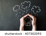 hands protects a house from the elements - rain or storm