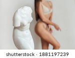 A woman's body near gypsum sculpture