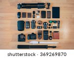 Professional photo camera kit is neatly folded on wood surface