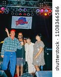 Small photo of Washington, DC., USA, October 3, 1993 Tom Arnold, Bruce Willis, Demi Moore and Roseanne Arnold on stage during the grand opening of the Planet Hollywood night club