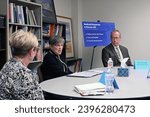 Small photo of EMPORIA, KANSAS, USA - NOVEMBER 14, 2023 Flanked by Desiree Straight of Family Childcare and Representative Mark Schreiber Kansas Governor Laura Kelly (D) heads a panel on Medicaid expansion