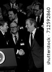 Small photo of Washington. DC. USA, 30th January,1984 President Ronald Reagan attends the National Religious Broadcasters Convention and shakes hands with Revend Jerry Falwell between them is Ben Armstrong