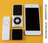 Small photo of BERRY, AUSTRALIA - June 20 2016 : A group of Apple iPods - iPod Nano 6th generation, iPod Shuffle 1st generation, iPod Touch 5th generation and iPod Nano 4th generation - on a plain yellow background.