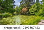 Small photo of Beautiful lake and rockery in Cambridge University Botanic Garden. Cambridge, UK