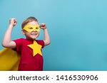 Little child superhero with yellow cloak and star. Happy smiling kid in glasses ready for education. Success, motivation concept. Back to school. Little businessman isolated on blue, Boy superhero. 