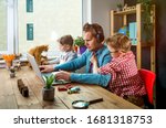 Work from home. Man works on laptop with children playing around. Family together with pet cat on table