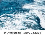 High angle of ship trail forming wave on surface of blue water of sea on Isla de Lobos. Abstract background of seawater
