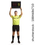 Small photo of Full length portrait of football referee holding a substitute board isolated on white background