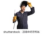 Young welder in a uniform and a shield on his head holding a welding machine isolated on white background